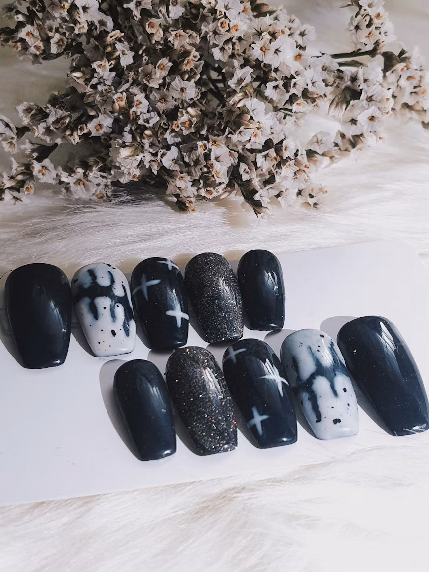 Black and white press-on nail set with ghost and glitter designs.